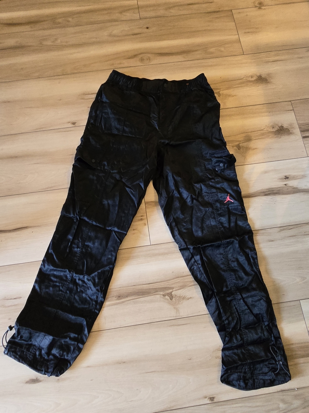 These are Nike Air Jordan Heritage Utility Cargo Track Pants in black. 